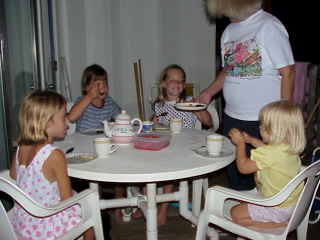 Granny having a tea party with the little girls